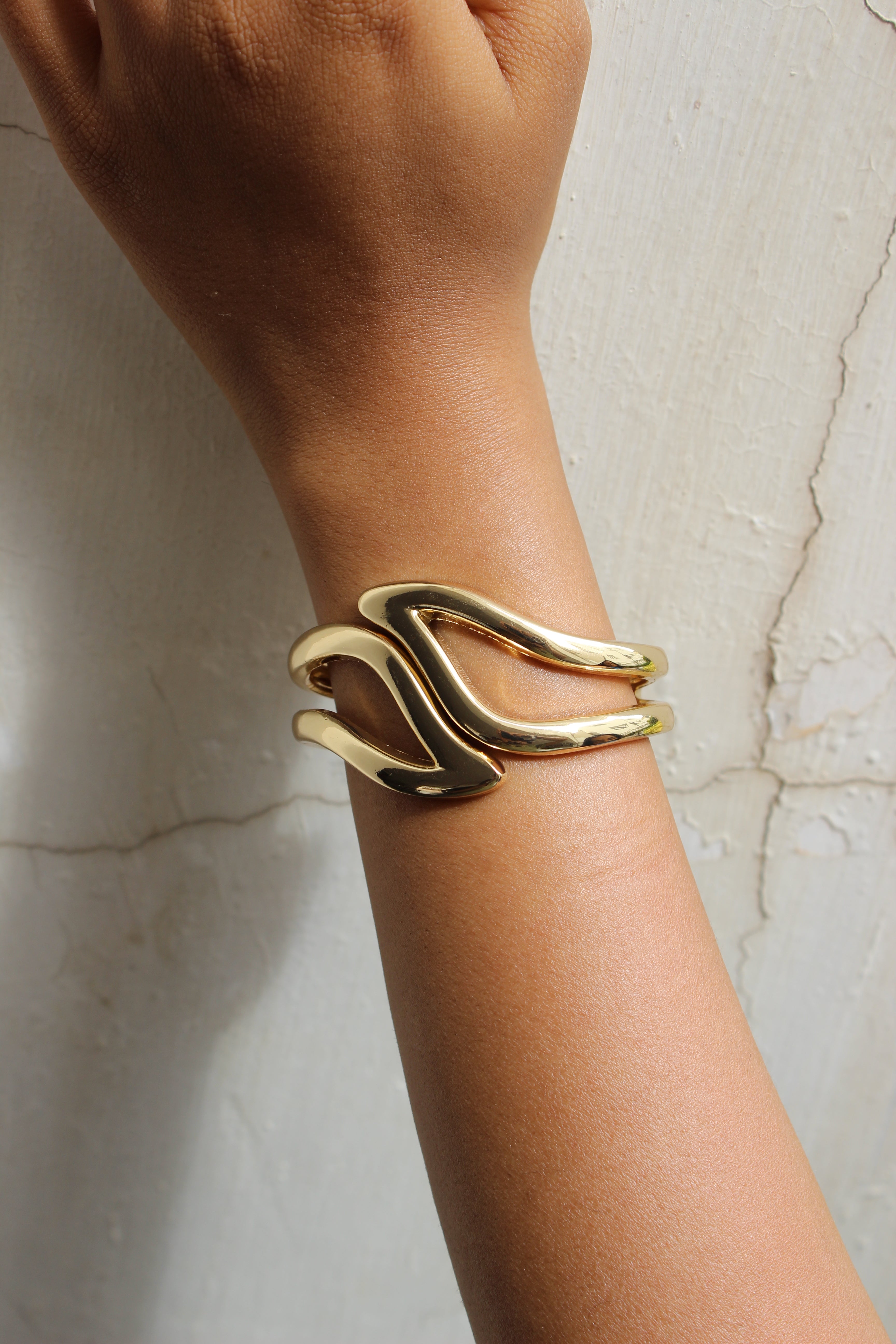 Heavy Petal Bracelet on a wrist against a marble background