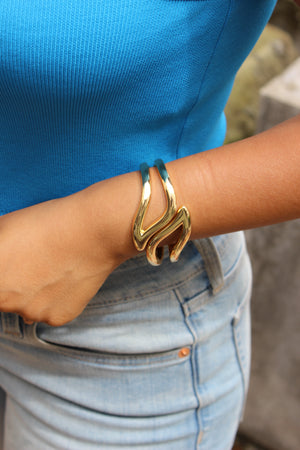 Heavy Petal Bracelet on a wrist with a blue shirt and denim jeans in the background