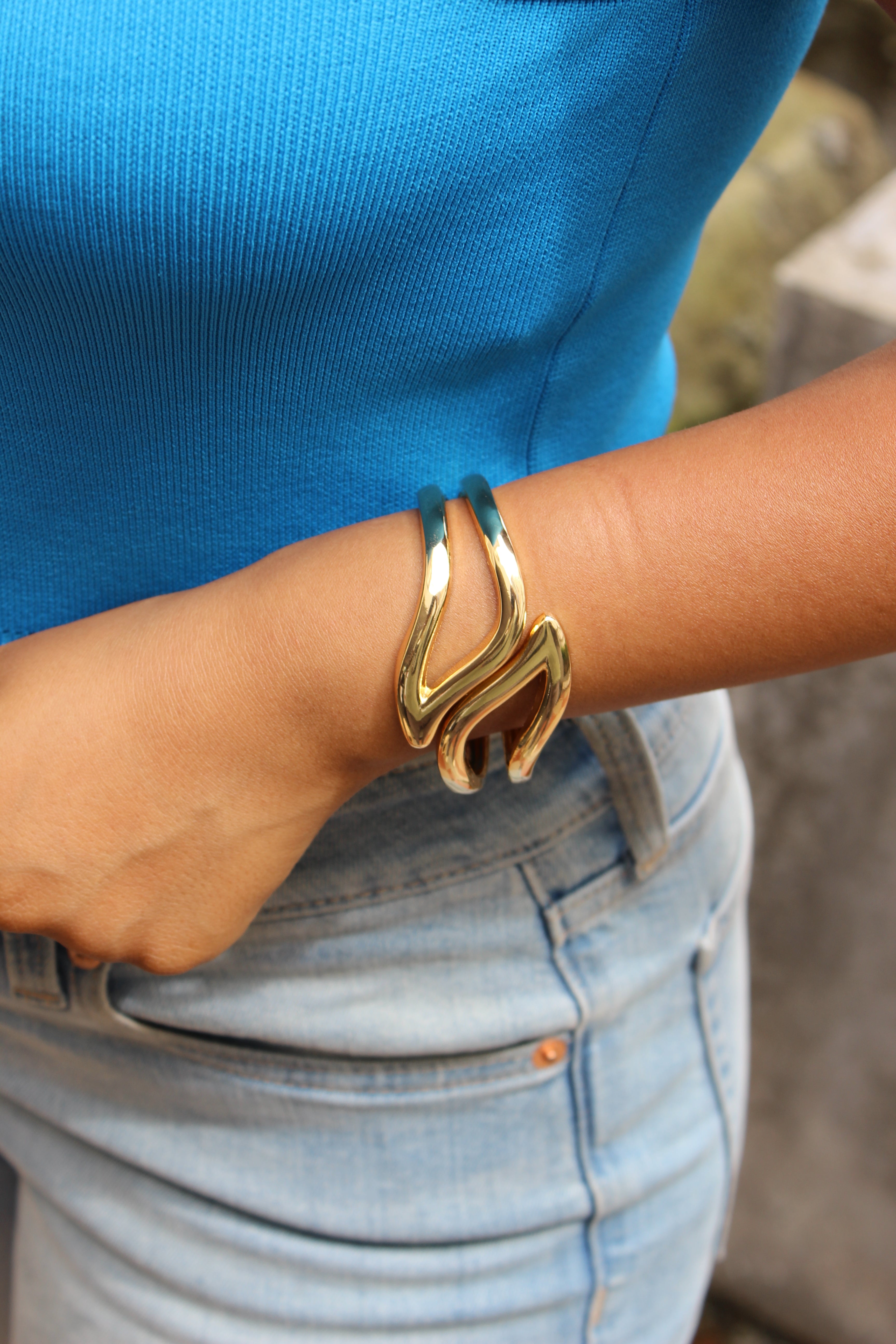 Heavy Petal Bracelet on a wrist with a blue shirt and denim jeans in the background