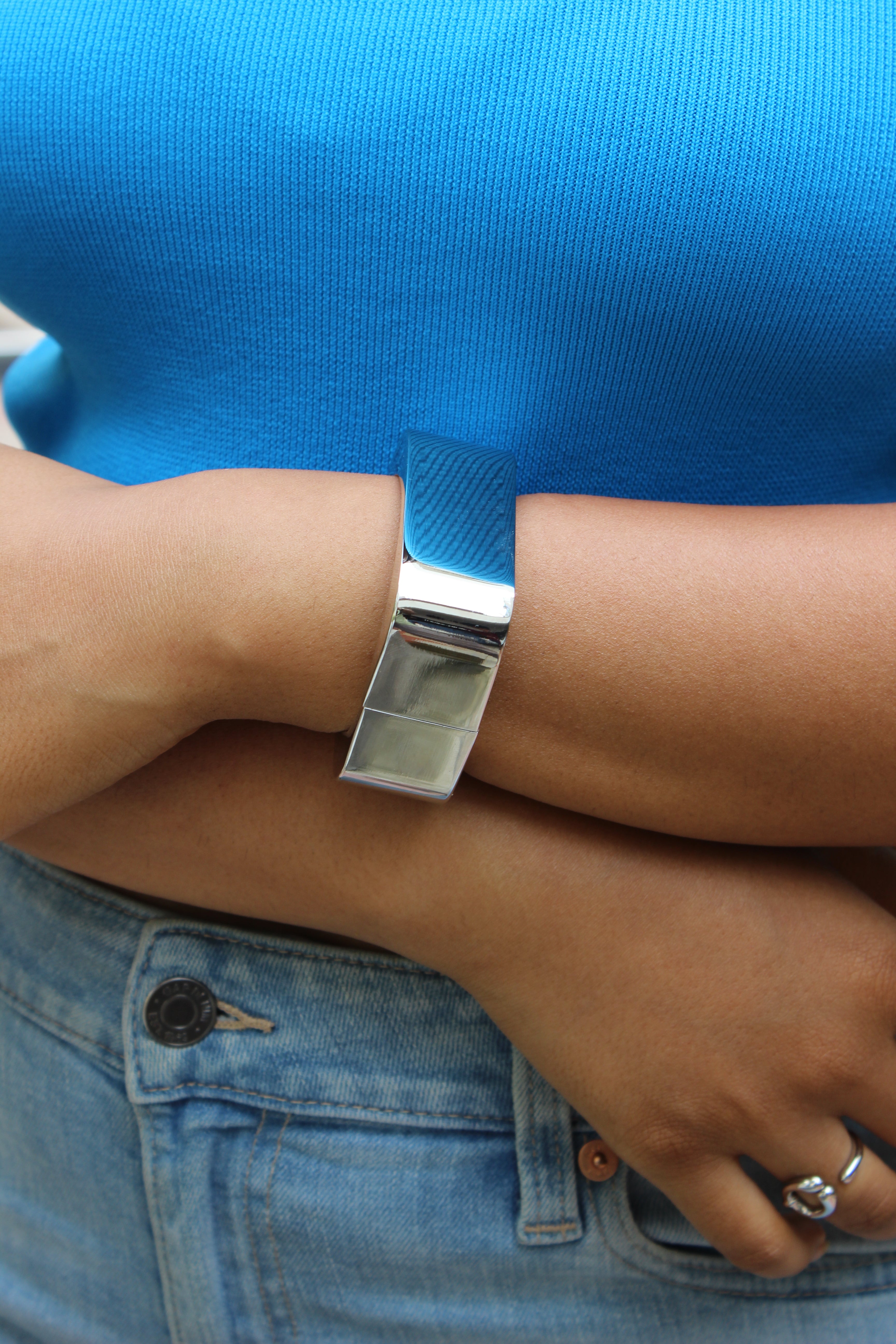 Lucid Hour Bracelet on a wrist with a blue shirt and jeans background