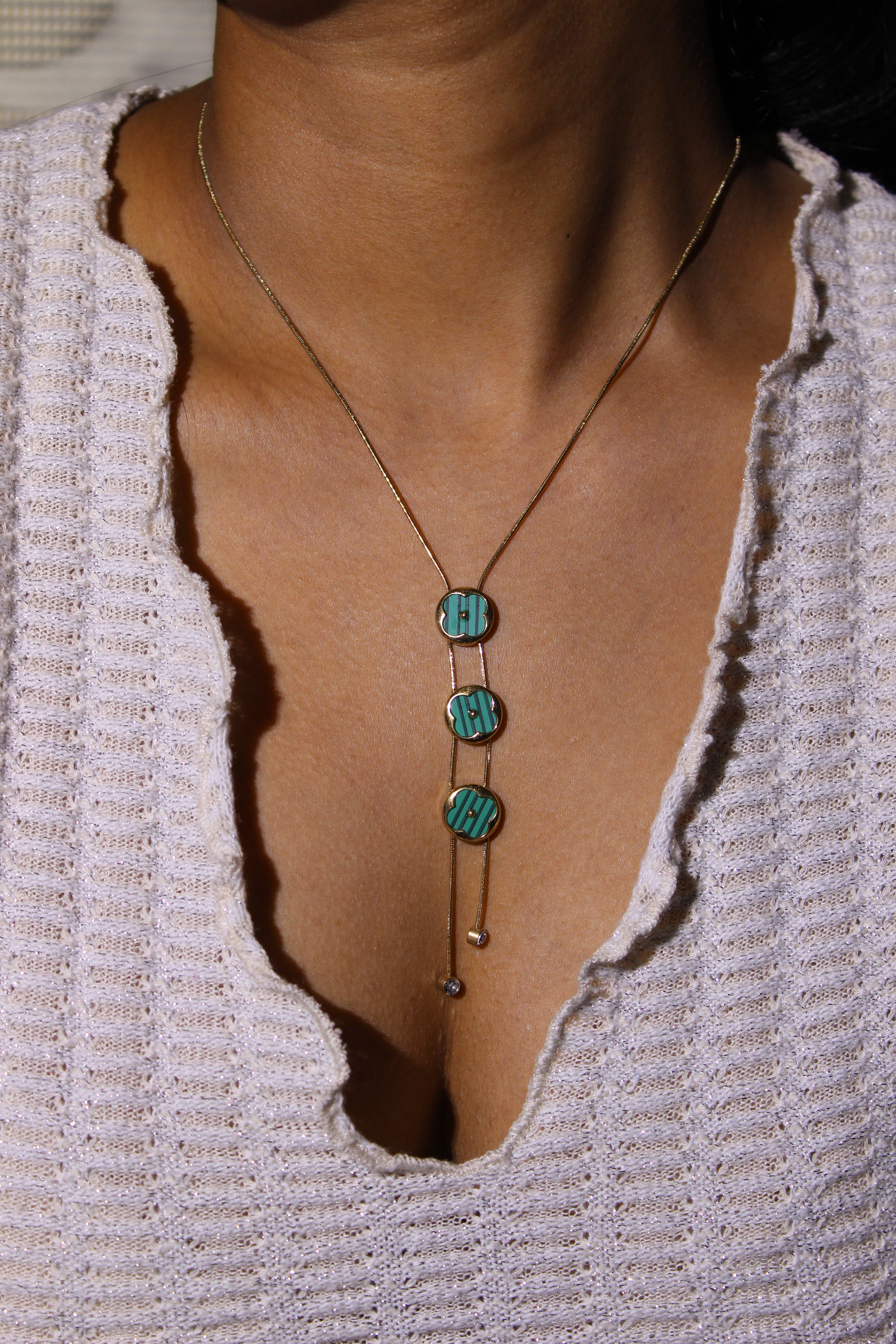 Green Mirage Necklace on a textured surface