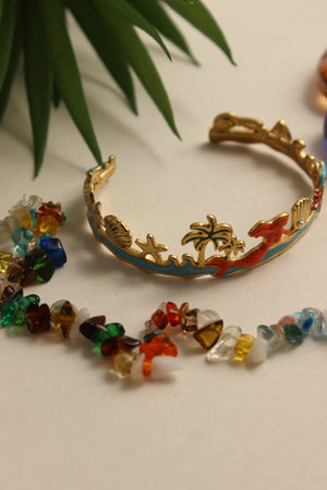 Shoreline Serenade Cuff Bracelet with a gold clasp on a light background