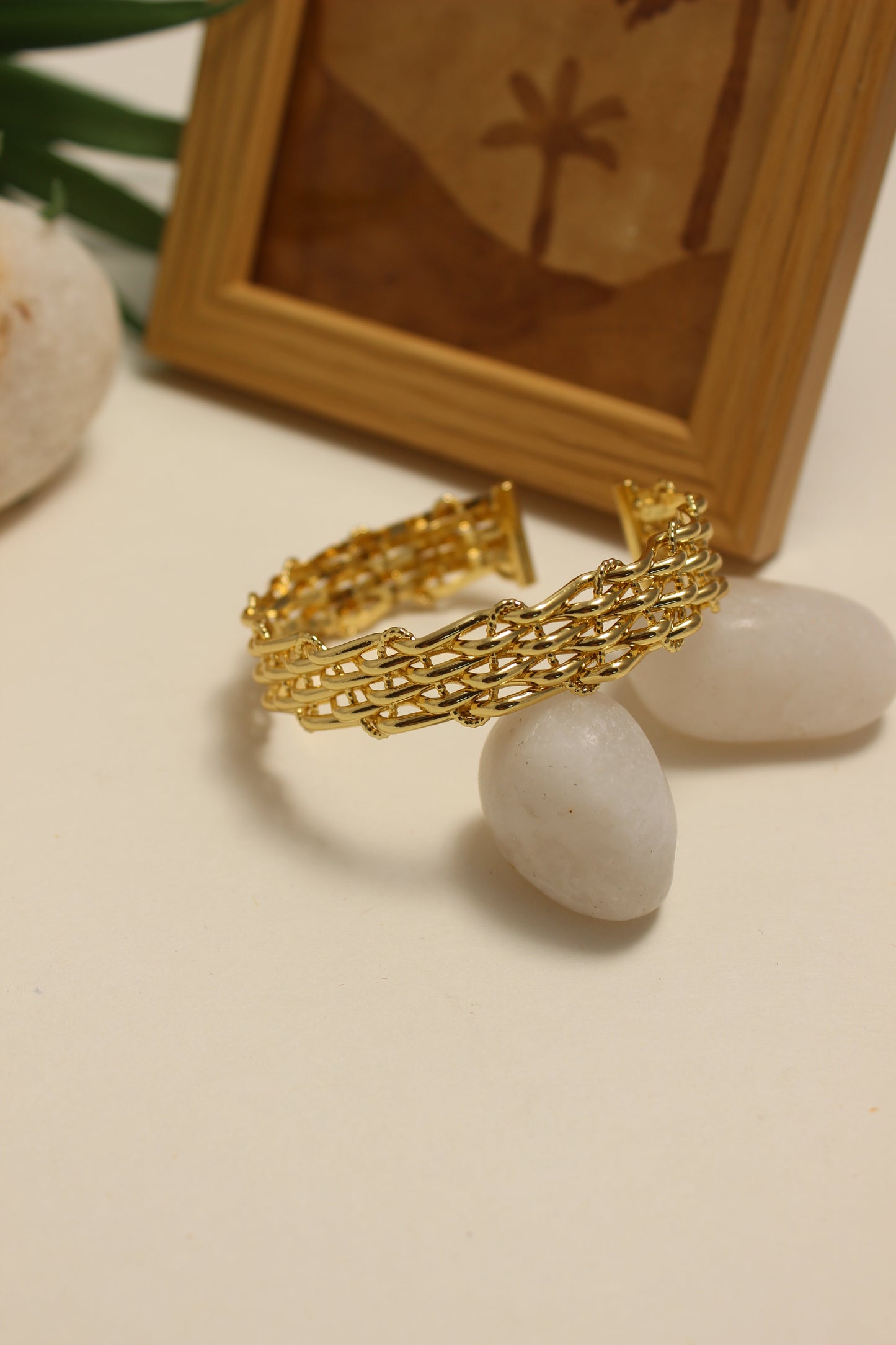 Legacy Cuff Bracelet on a textured surface with a wooden box in the background