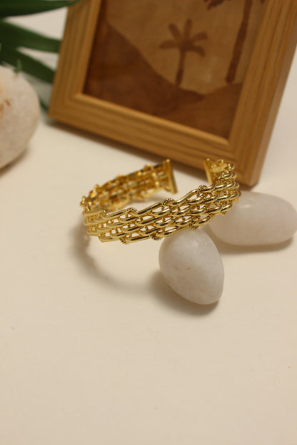 Legacy Cuff Bracelet on a textured surface with a wooden box in the background