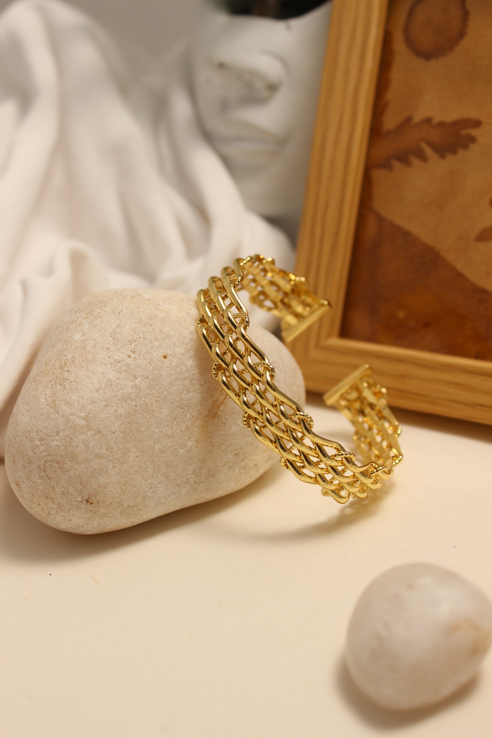 Legacy Cuff Bracelet on a stone surface with a soft focus background