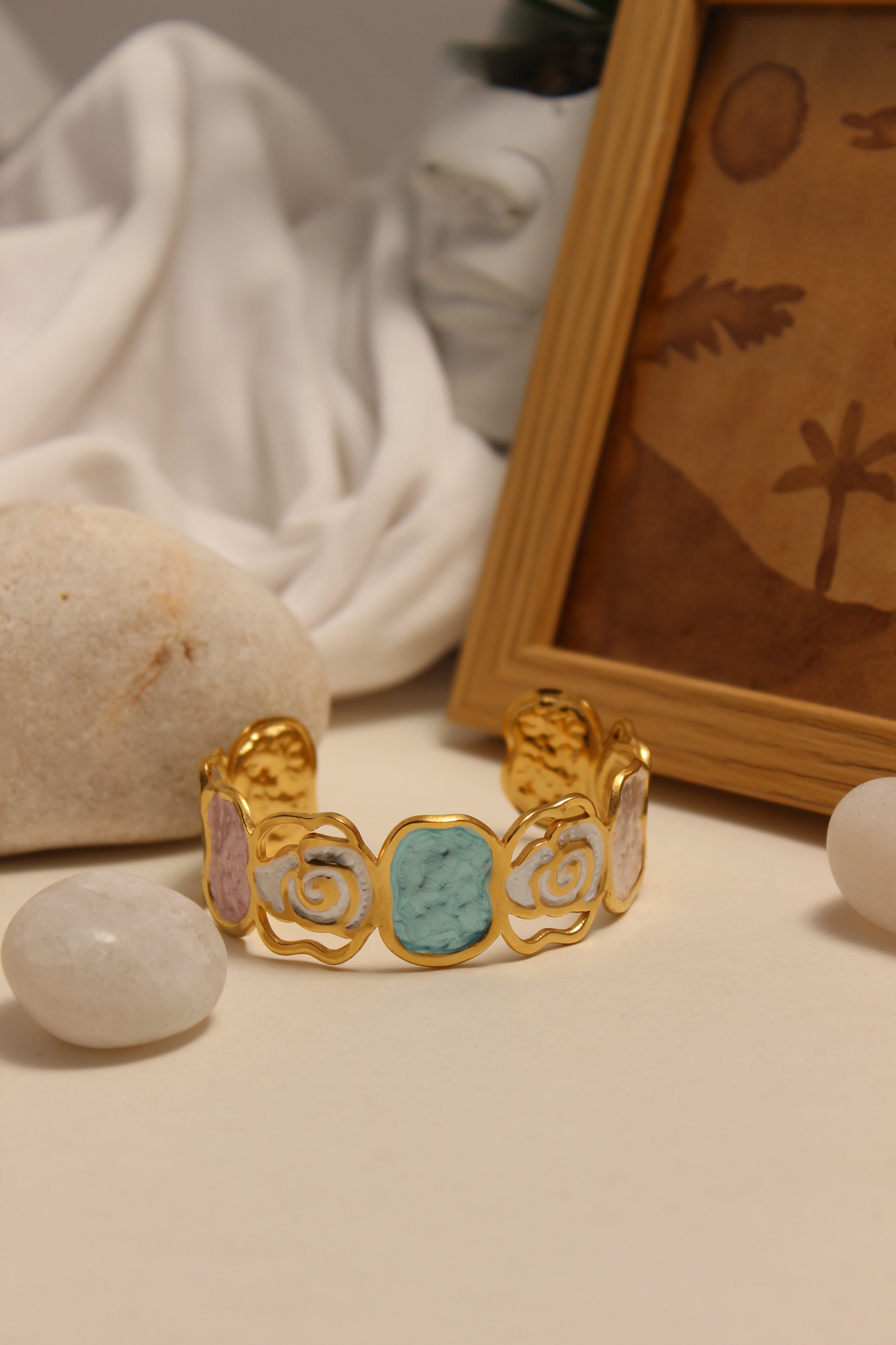 Pearled Blossom Cuff Bracelet on a textured surface