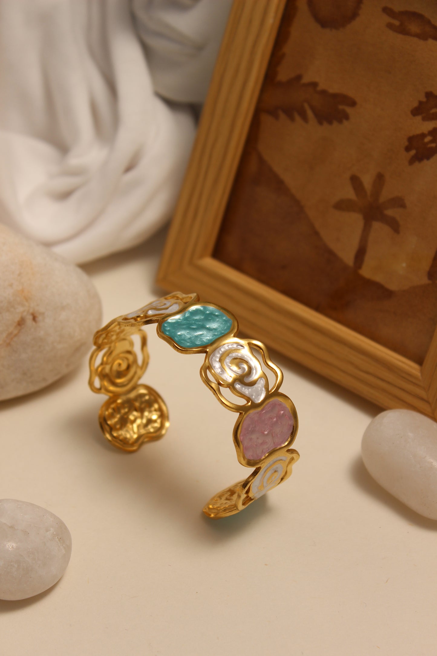 Pearled Blossom Cuff Bracelet with colorful stones on a textured surface
