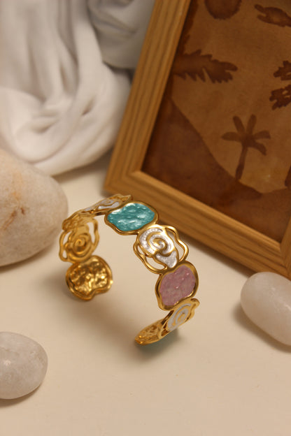 Pearled Blossom Cuff Bracelet with colorful stones on a textured surface