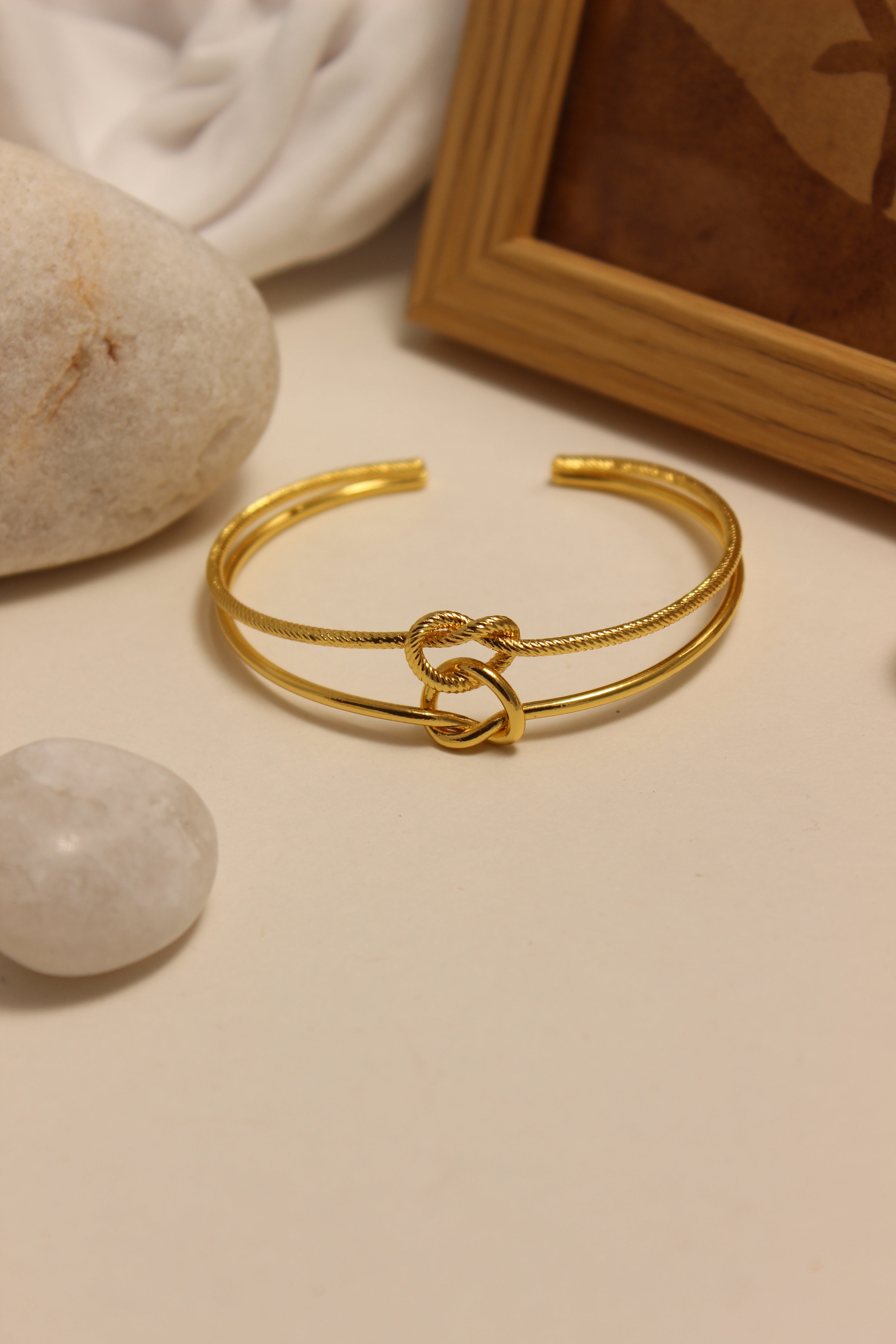 Eterna Knot Cuff Bracelet on a neutral background