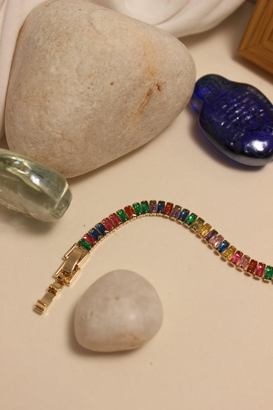Jeweltone Bracelet on a beige surface with stones and seashell