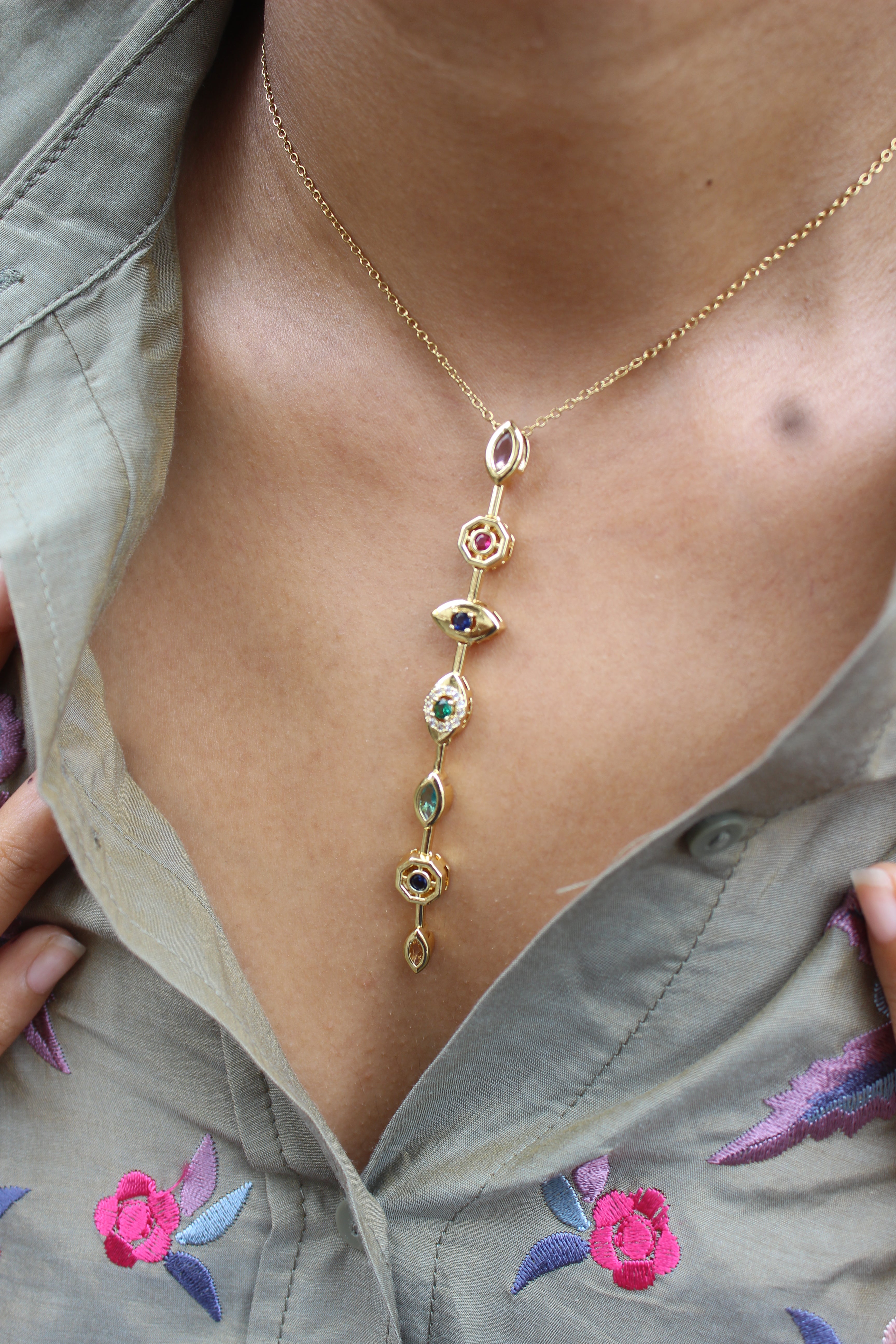 Lustre Pour Necklace with colorful gemstones on a model's neck