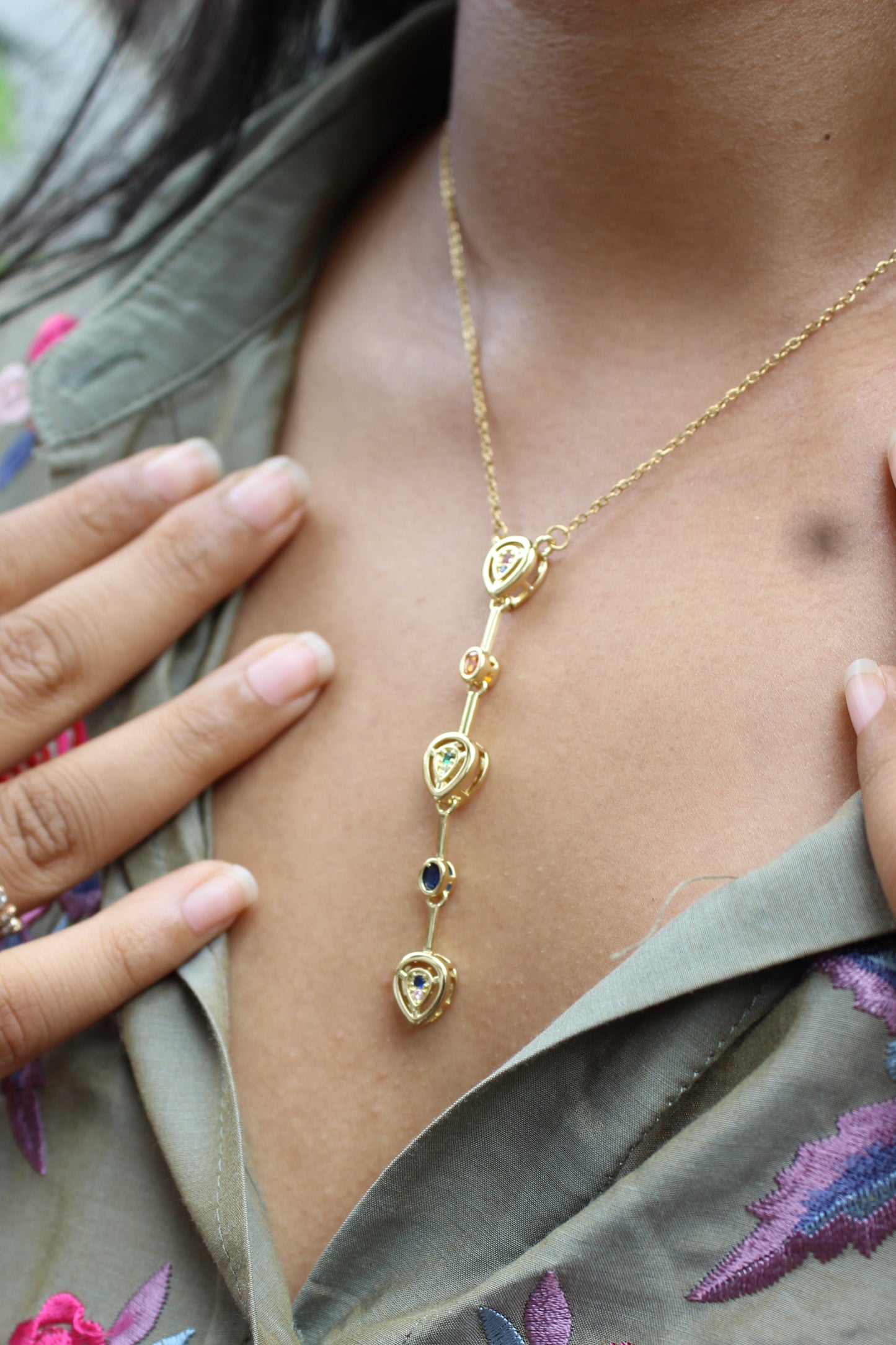 Serene Pour Necklace with heart-shaped charms worn by a model 