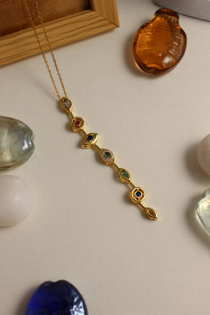 Lustre Pour Necklace with gemstones on a light surface 