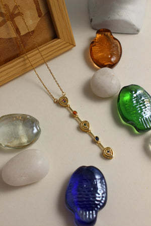 Serene Pour Necklace with colorful beads on a light surface