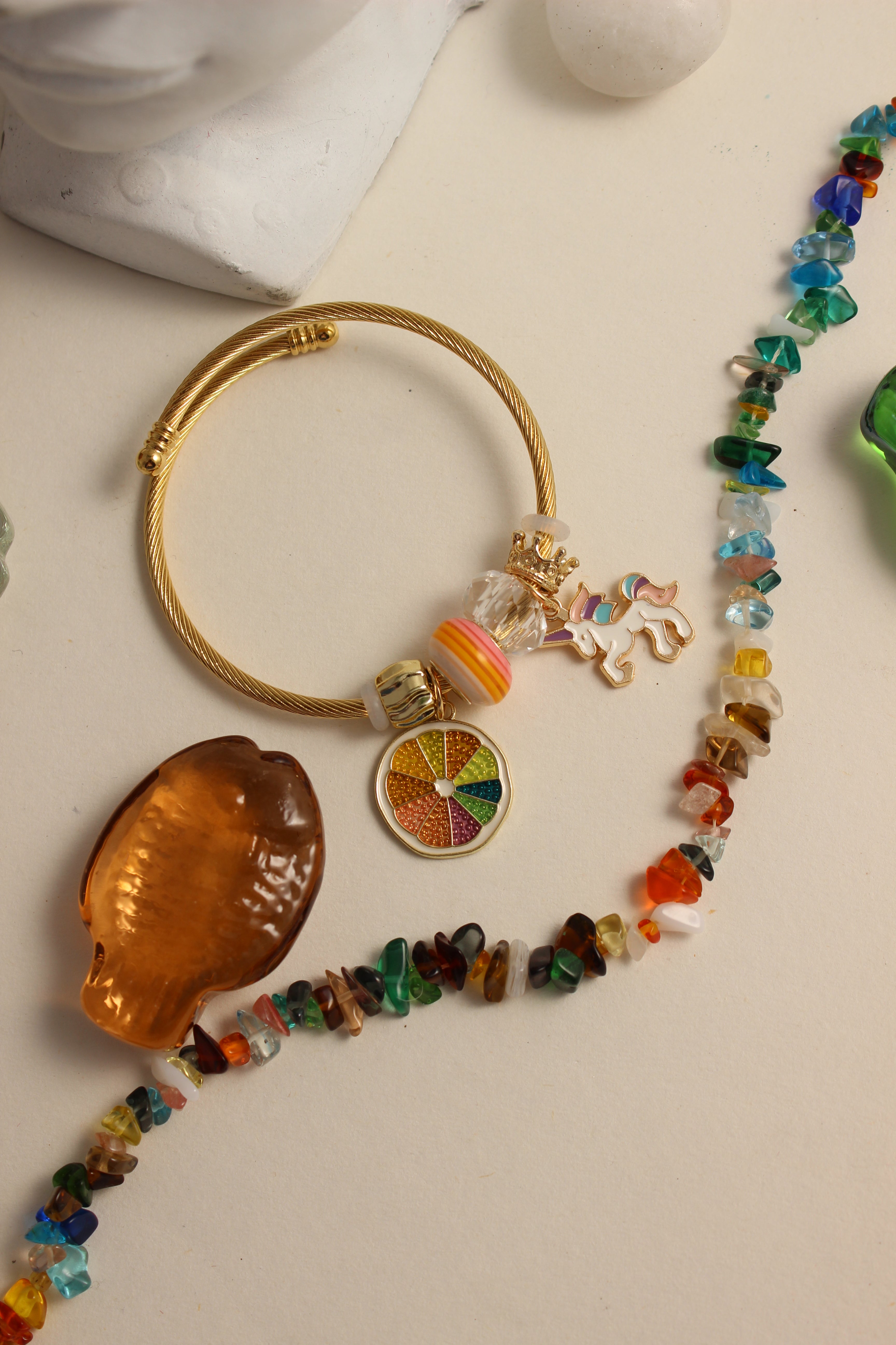 Citrus Carnival Bracelet, and shell on a light background