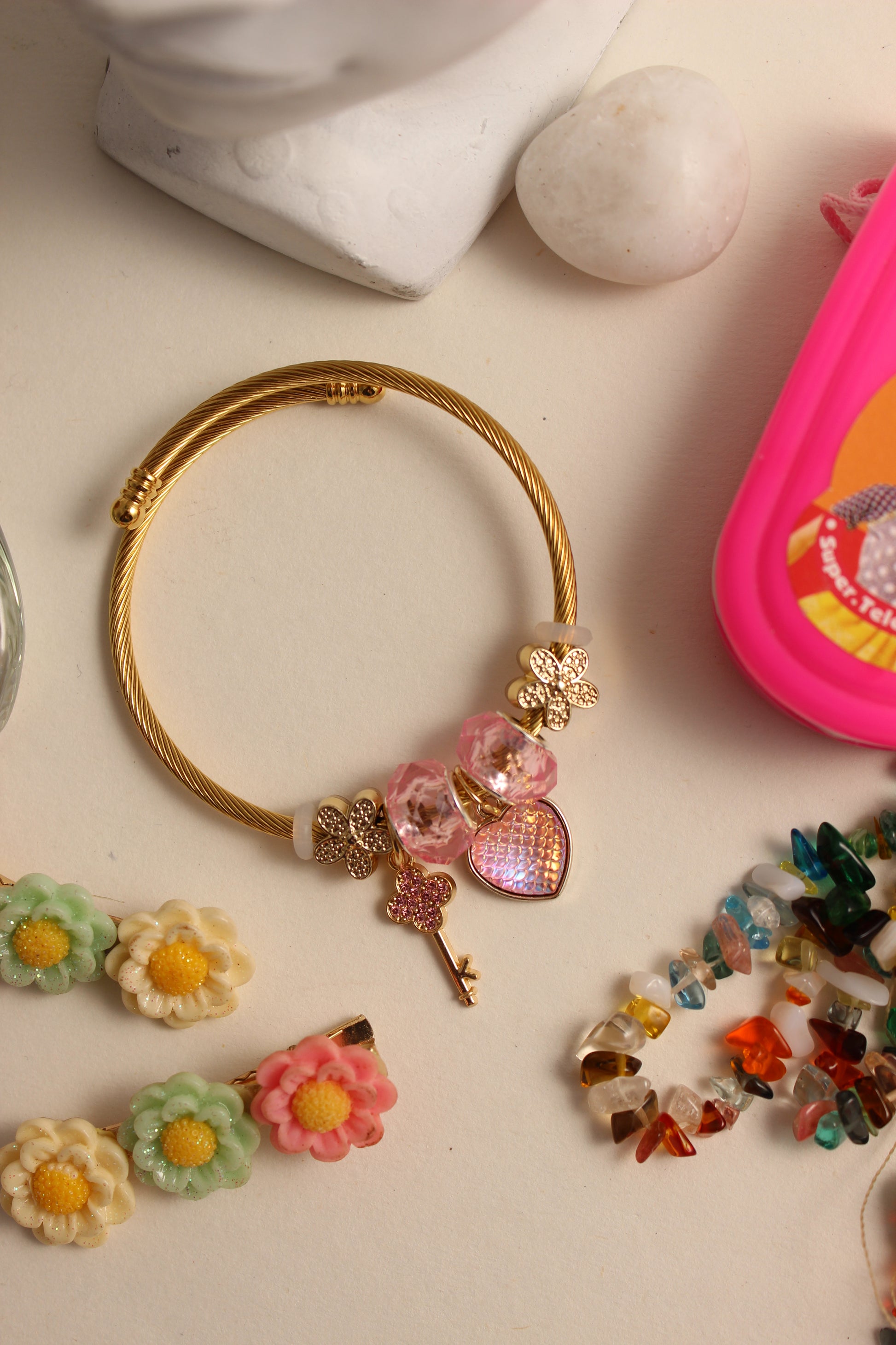 Secret Garden Bracelet with flowers and beads on a light surface