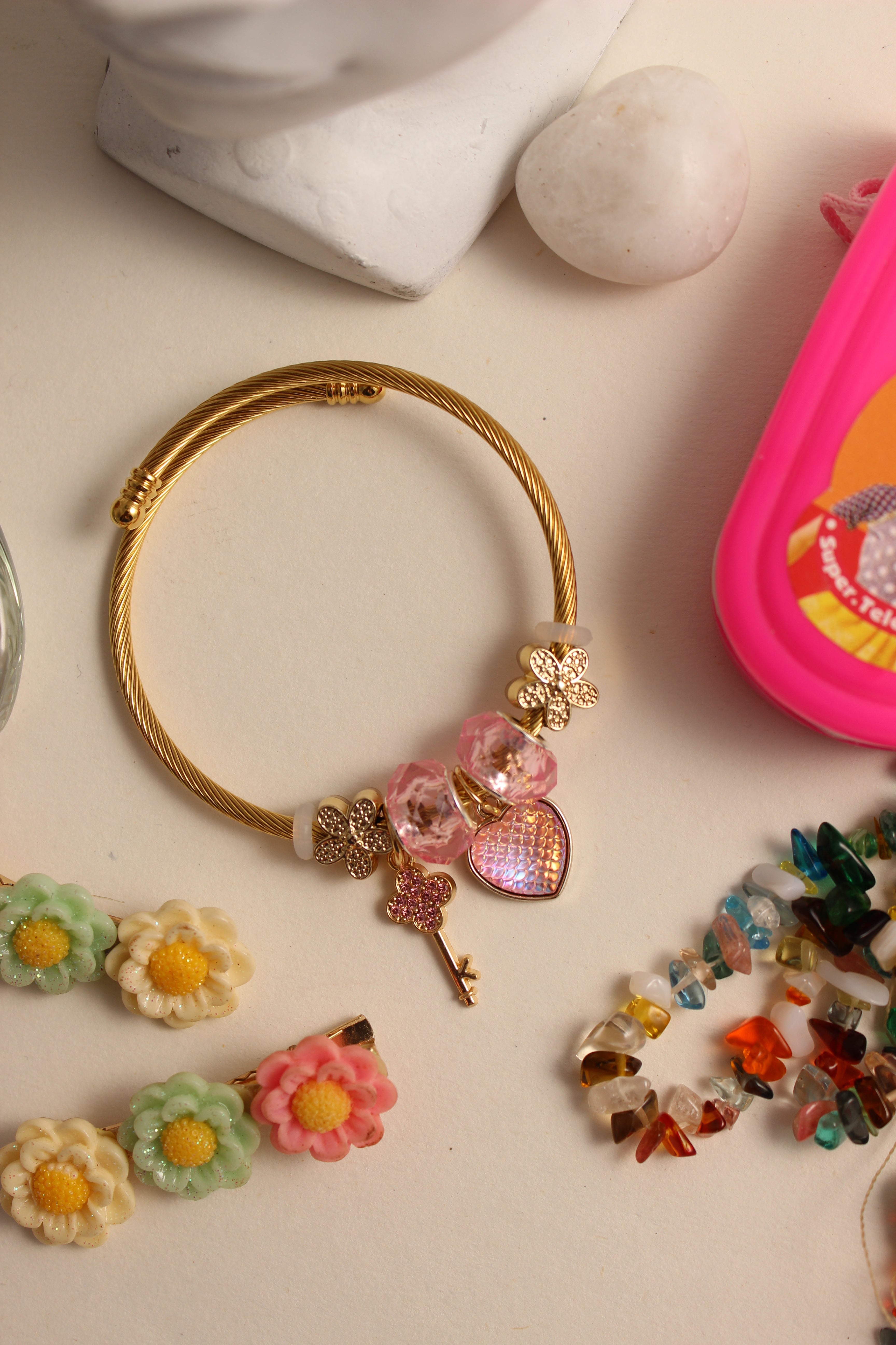 Secret Garden Bracelet with flowers and beads on a light surface