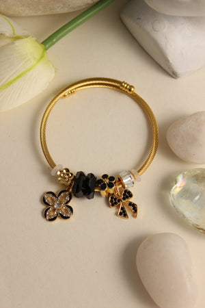 Noir Bloom Bracelet with black floral charm on a light background