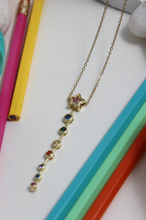 Nova Drip Necklace with colorful beads on a colorful background