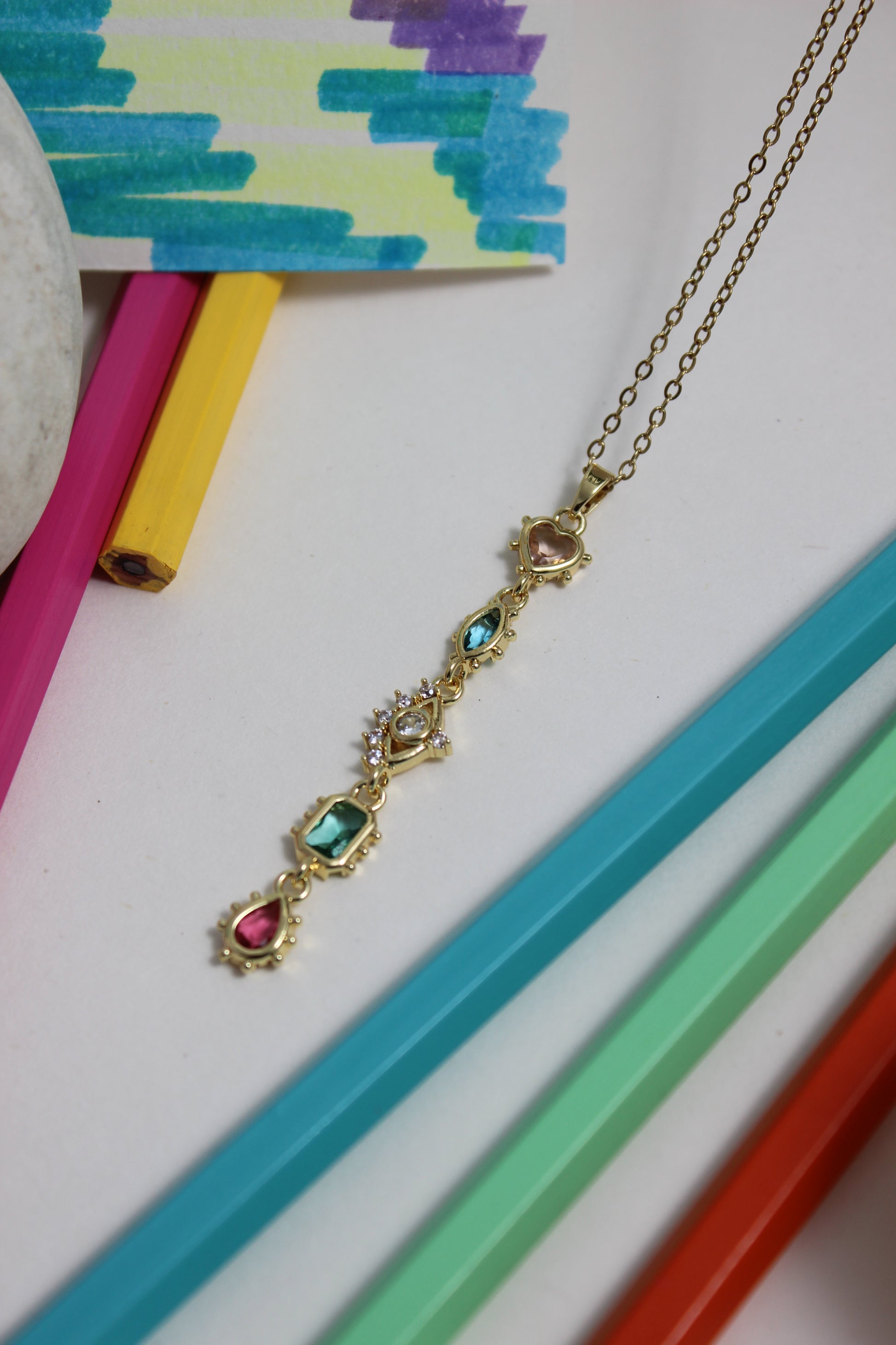 Fortuna Necklace with gemstones on a colorful background