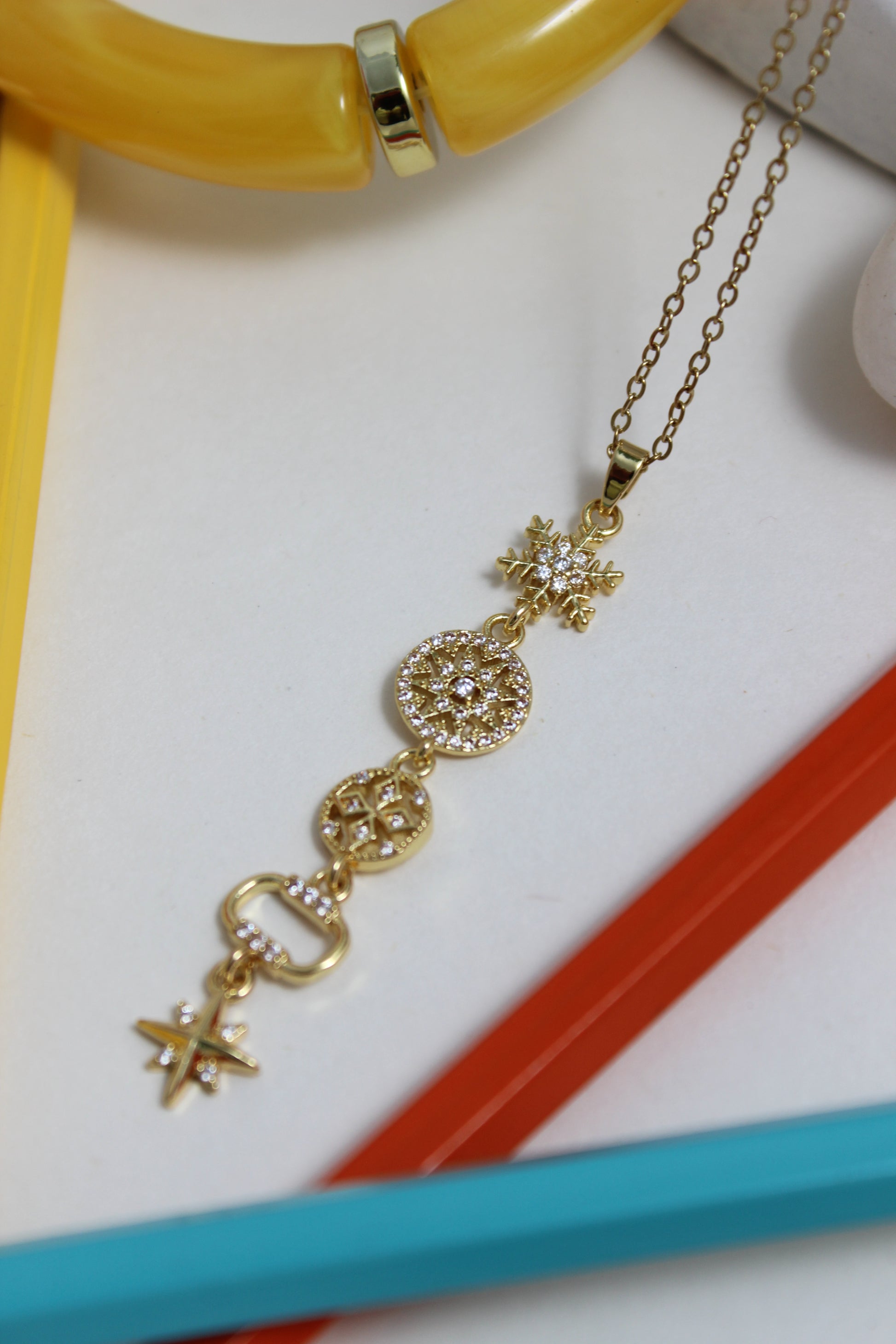 Northbloom Necklace with decorative pencils on a white background