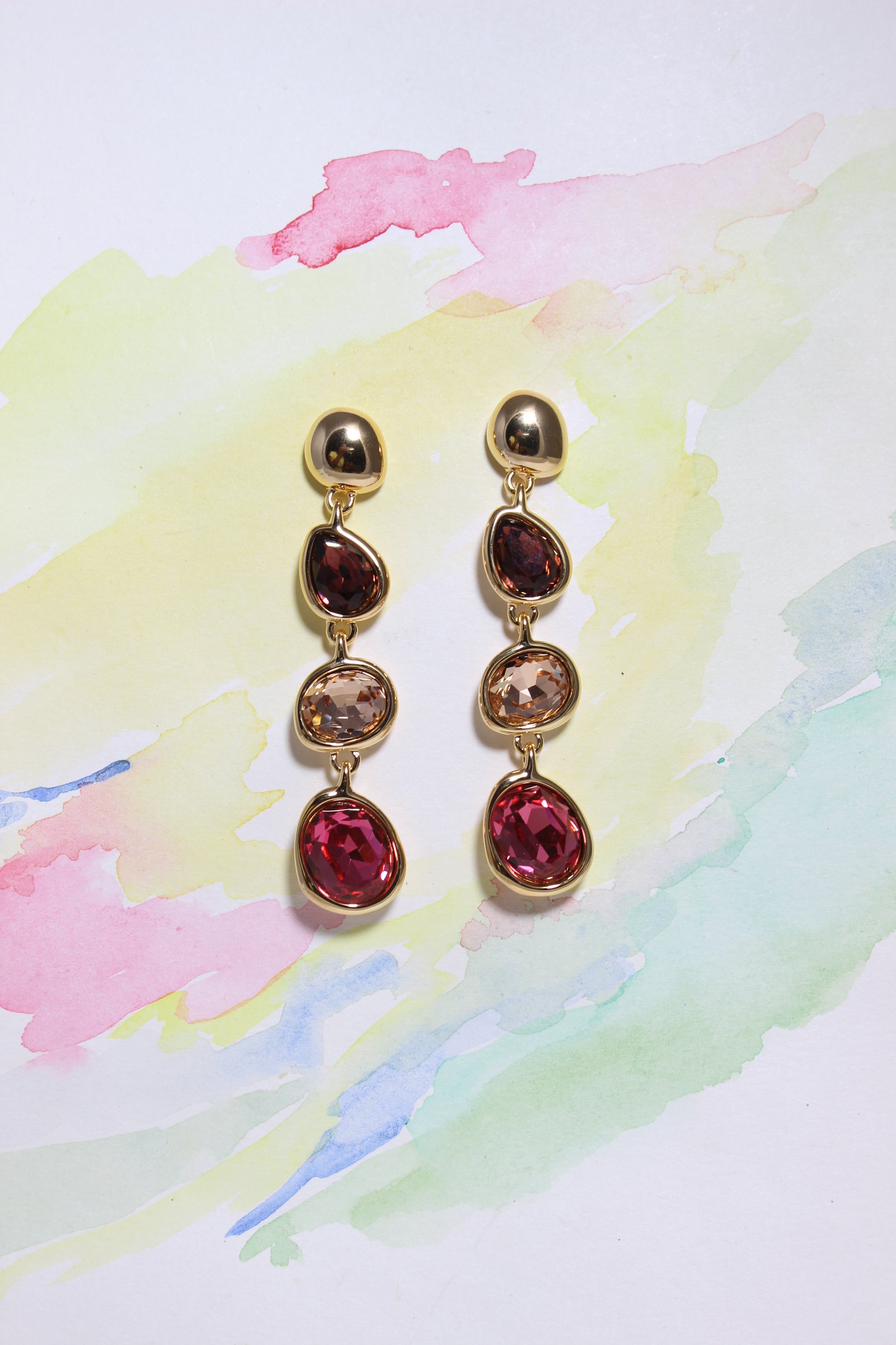 Sienna Bloom Earrings on a color background