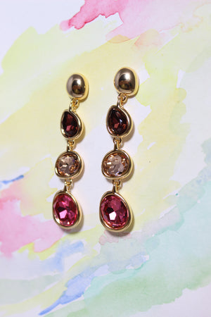 Sienna Bloom Earrings on a watercolor background