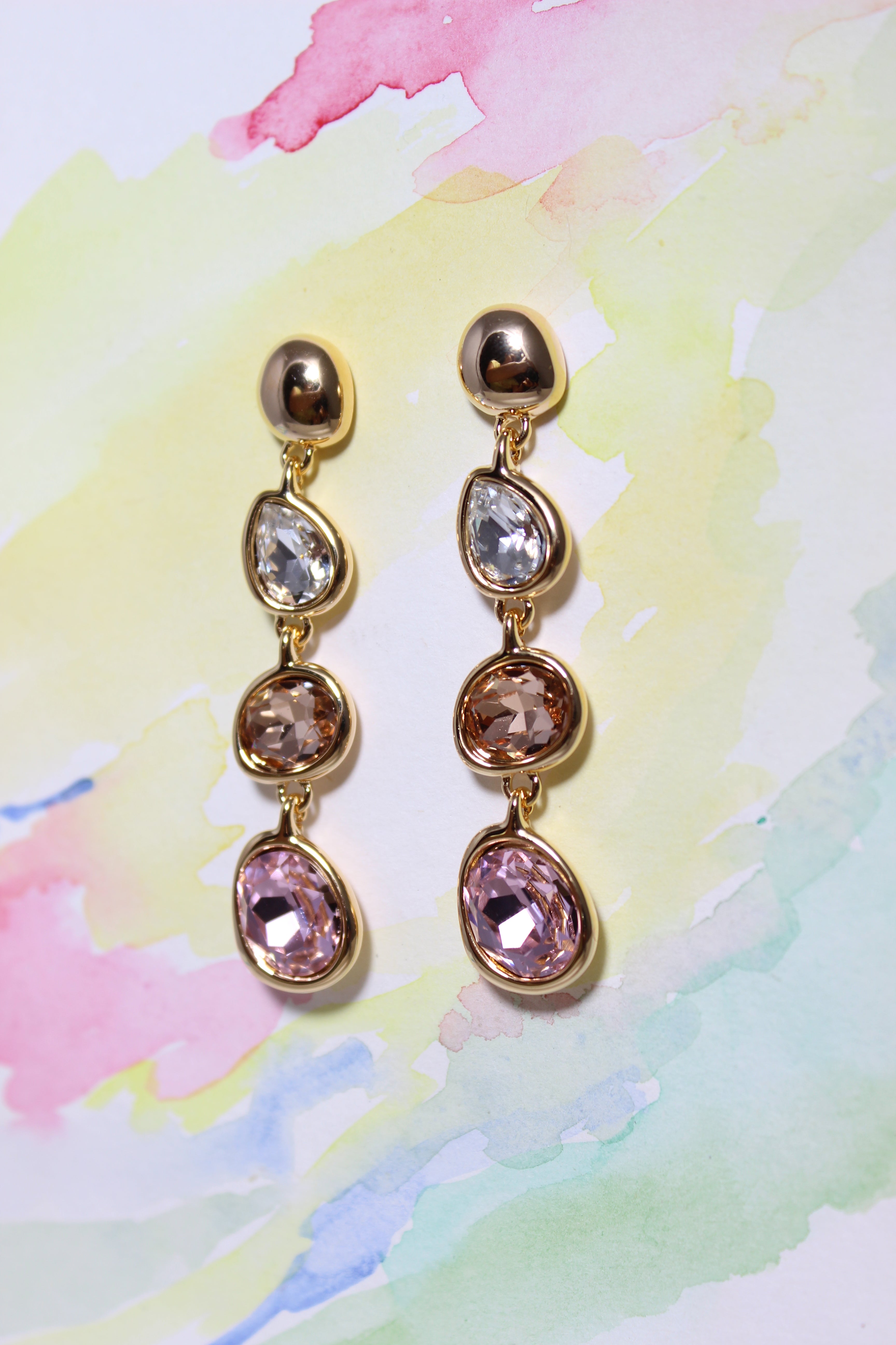 Auric Petals Earrings on a watercolor background