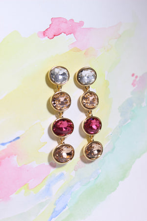 Radiance Veil Earrings on a colorful watercolor background