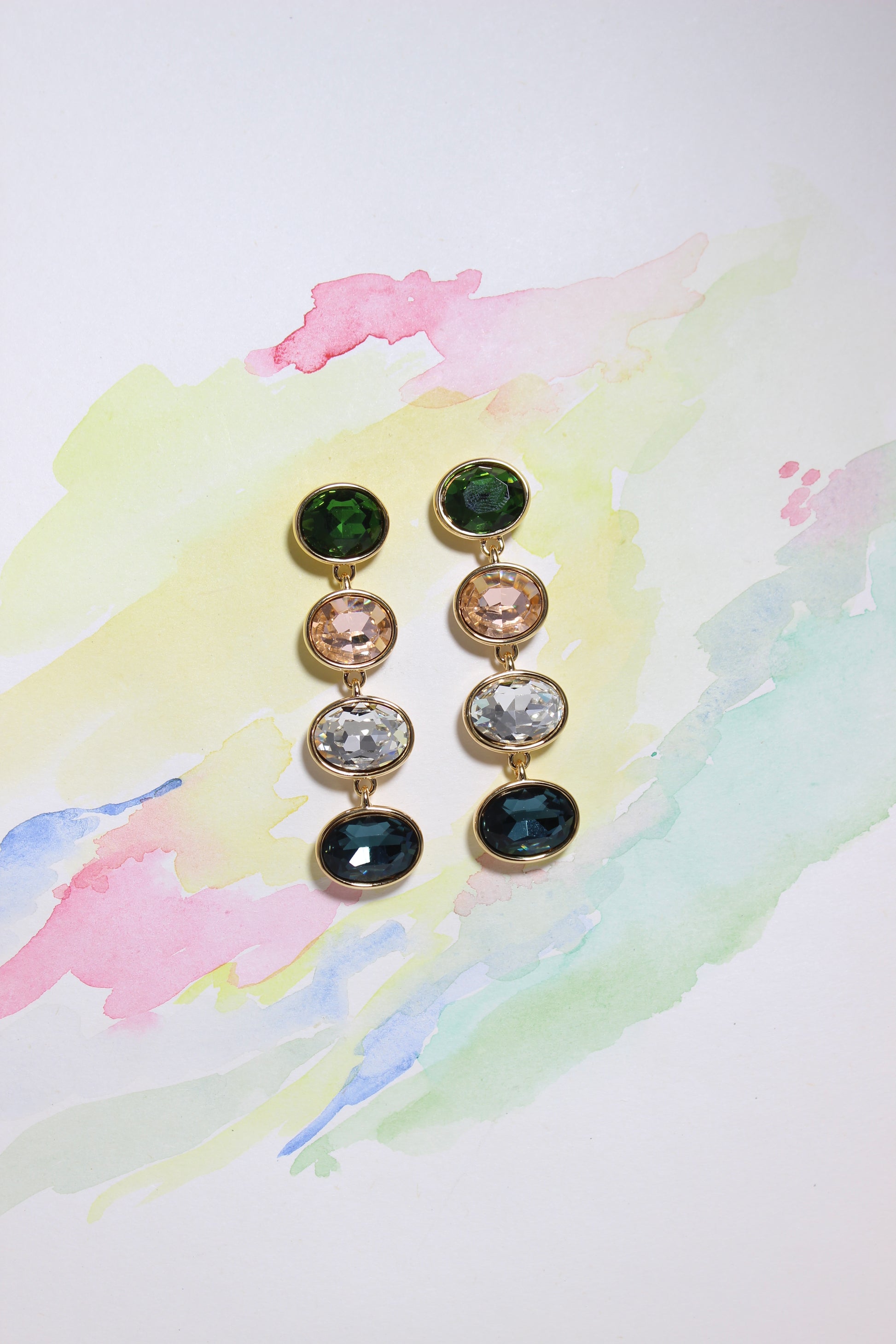 Set of Forest Light Earrings with multicolored gemstones on a watercolor background