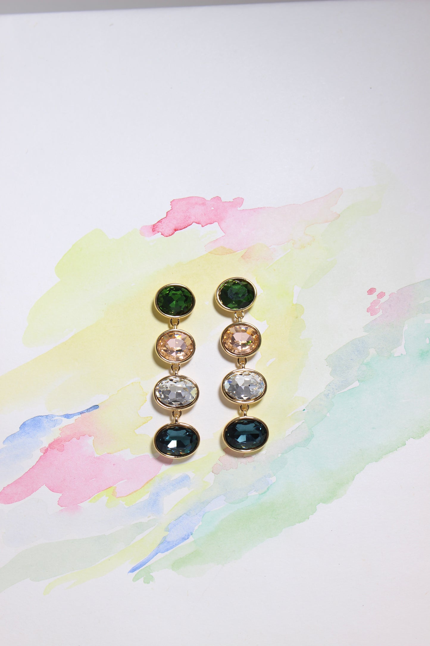 Set of Forest Light Earrings with colored stones on a watercolor background