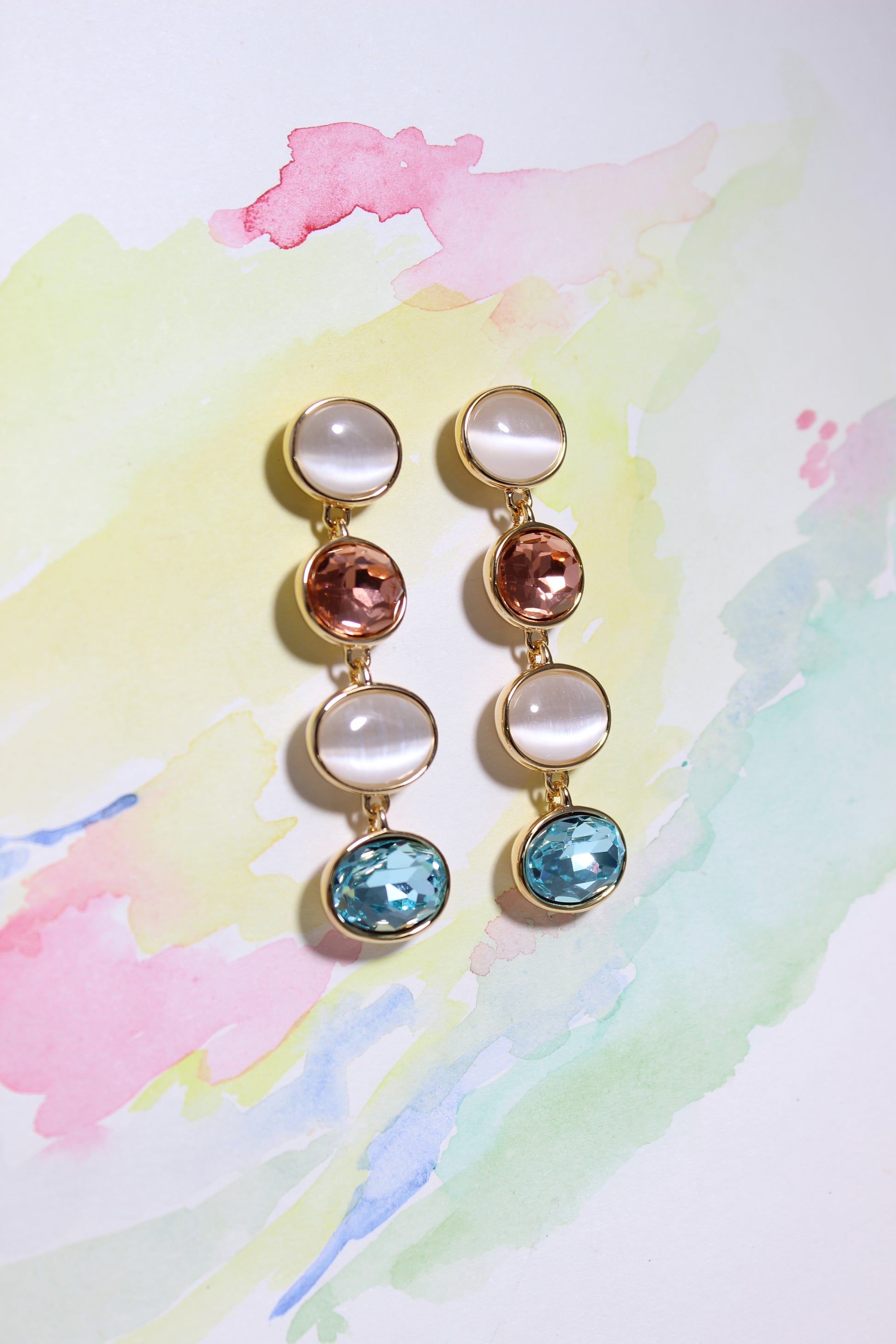 Set of colorful Morning Dew Earrings on a watercolor background