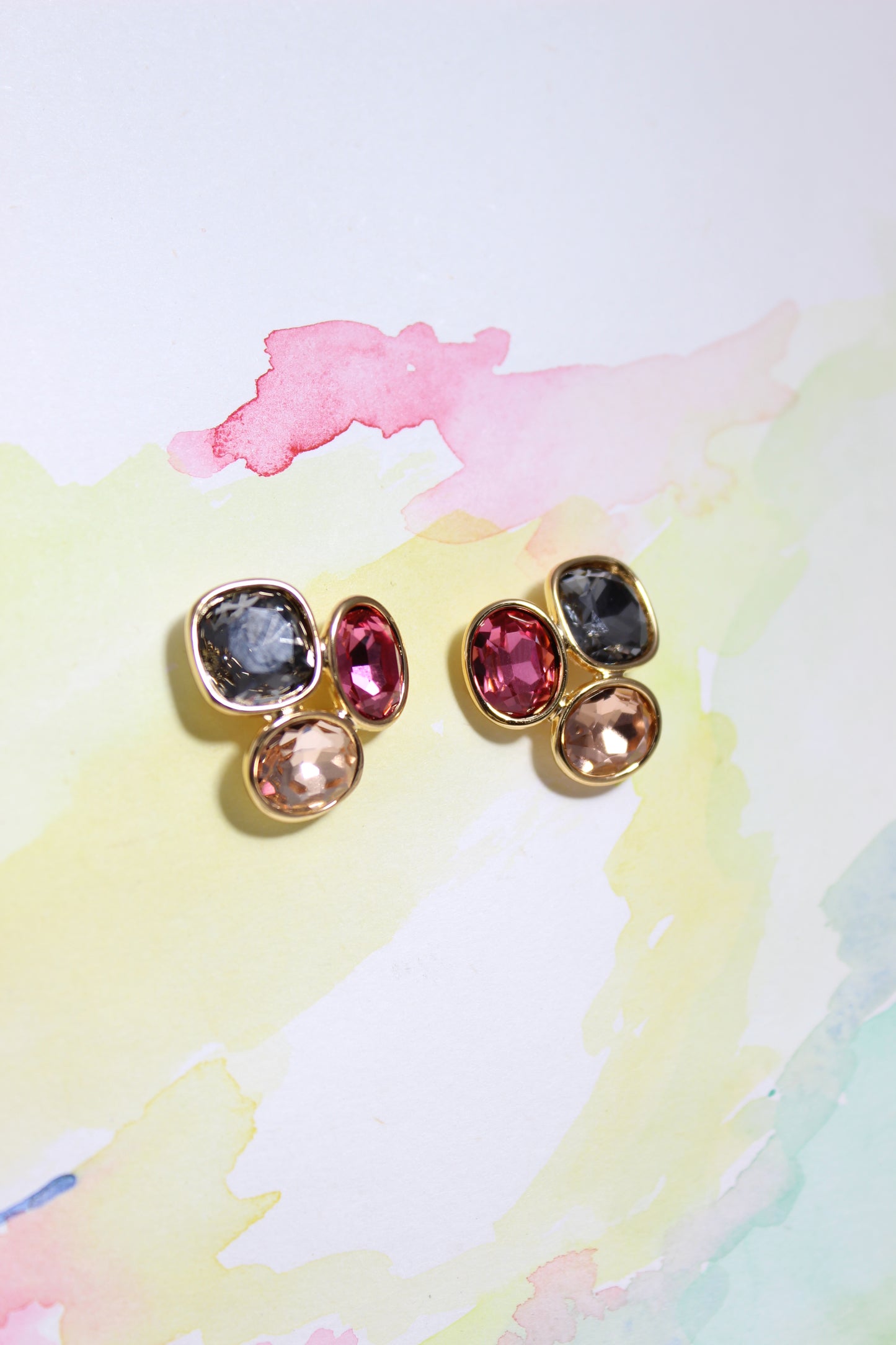 Colorful gemstone Solar Gleam Earrings on a watercolor background