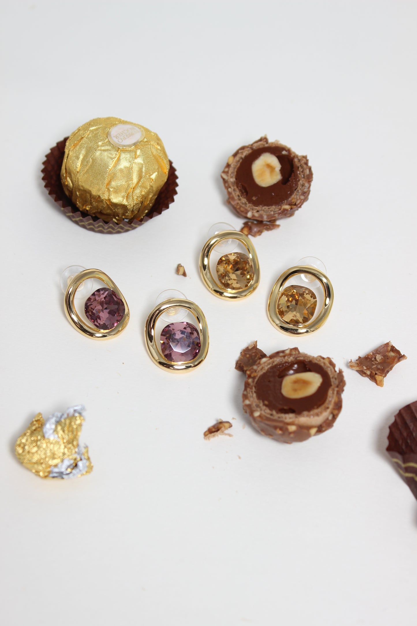 Decorative items resembling chocolates with Sable Soleil Earrings on a white background