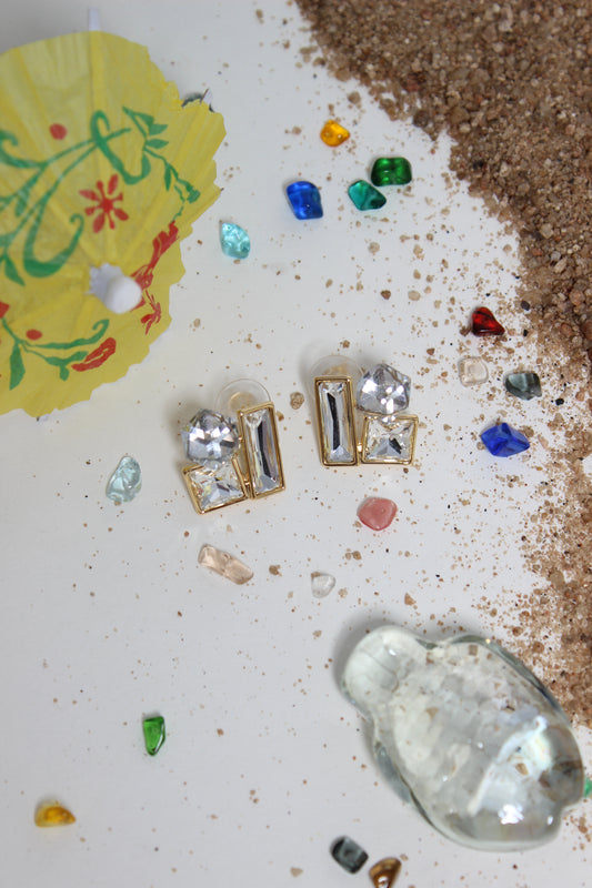 Moonlight Glow Earrings on a textured surface