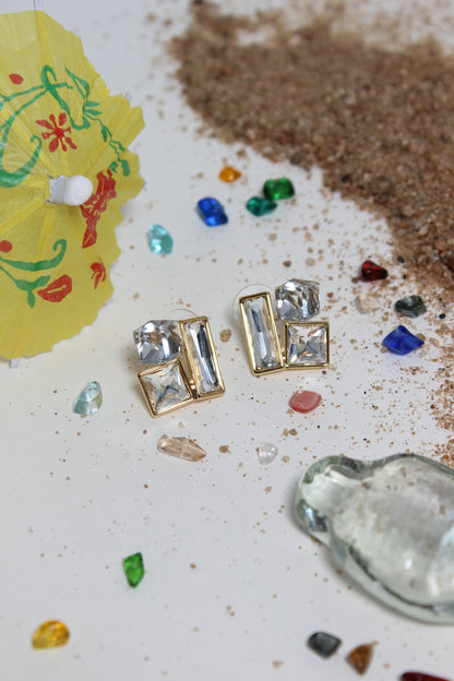 Moonlight Glow Earrings on a textured surface
