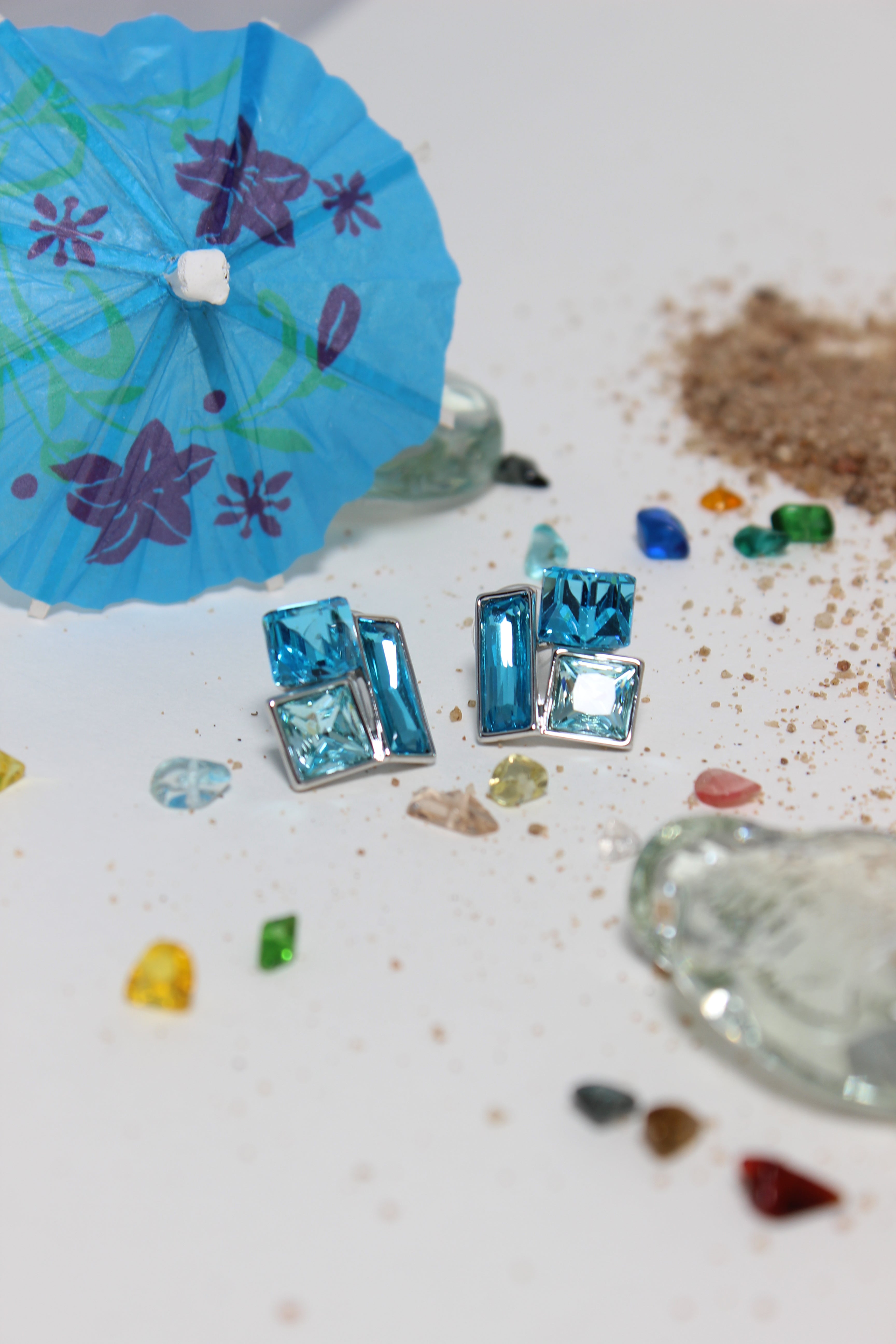 Azure Glow Earrings on a textured surface