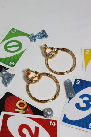Cosmo Ring Earrings on a white surface with game cards and small figurines
