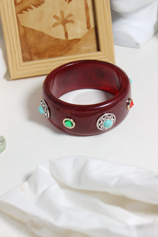 Regalia Bangle on a white fabric background