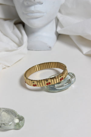 Cherry Twist Bracelet with seashell on a white surface