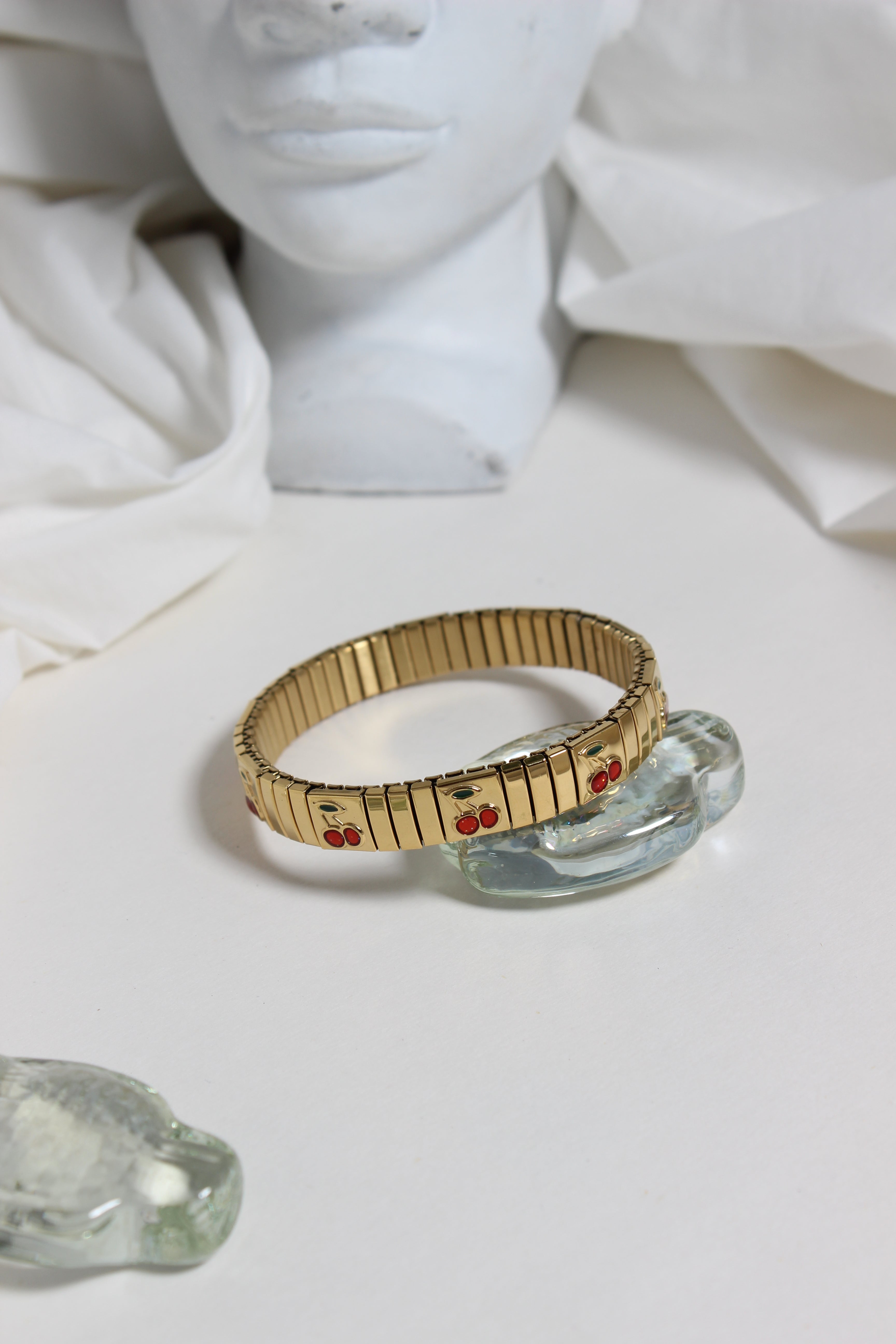 Cherry Twist Bracelet with seashell on a white surface