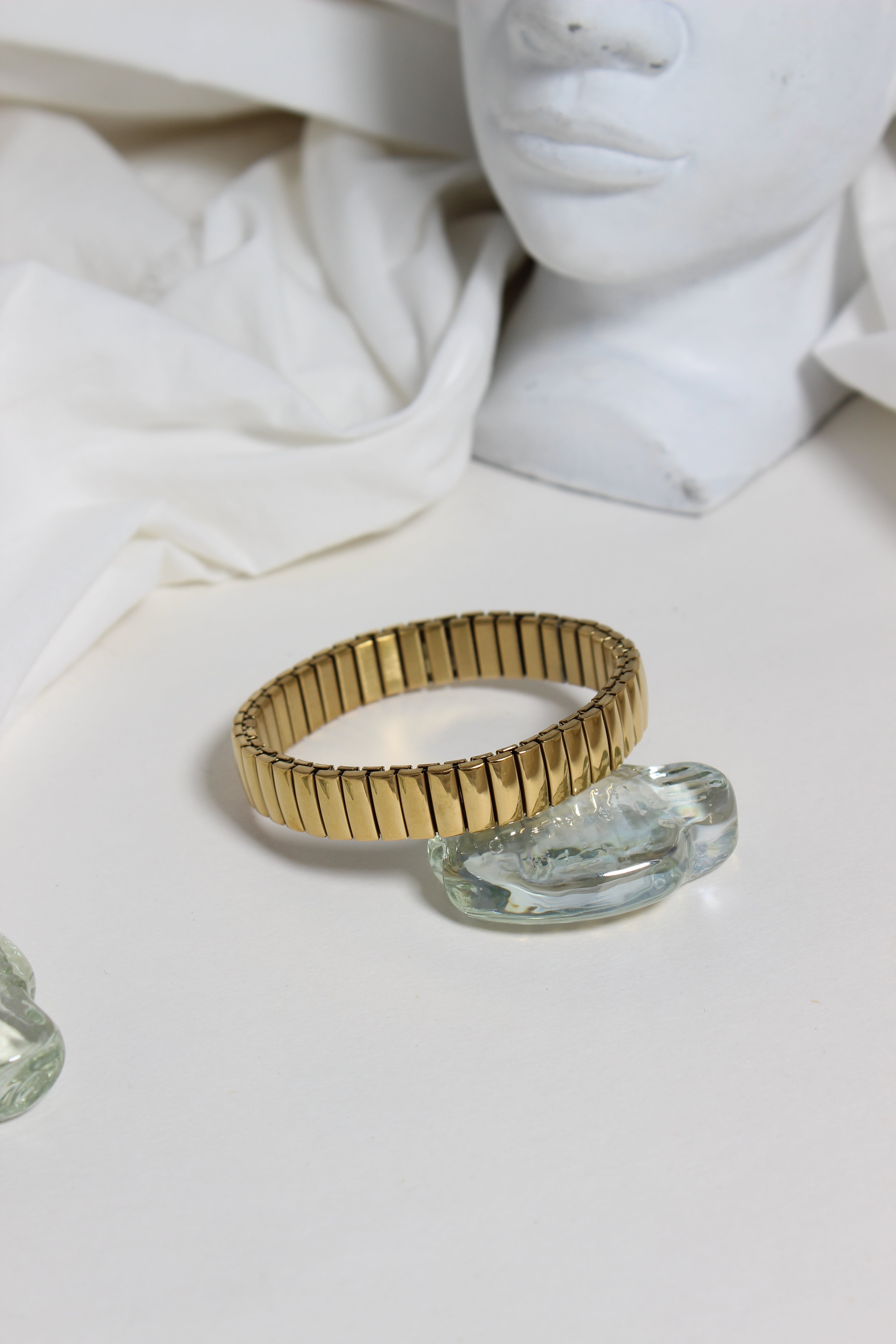 Timeless Gleam Bracelet on a white surface with marble-like texture