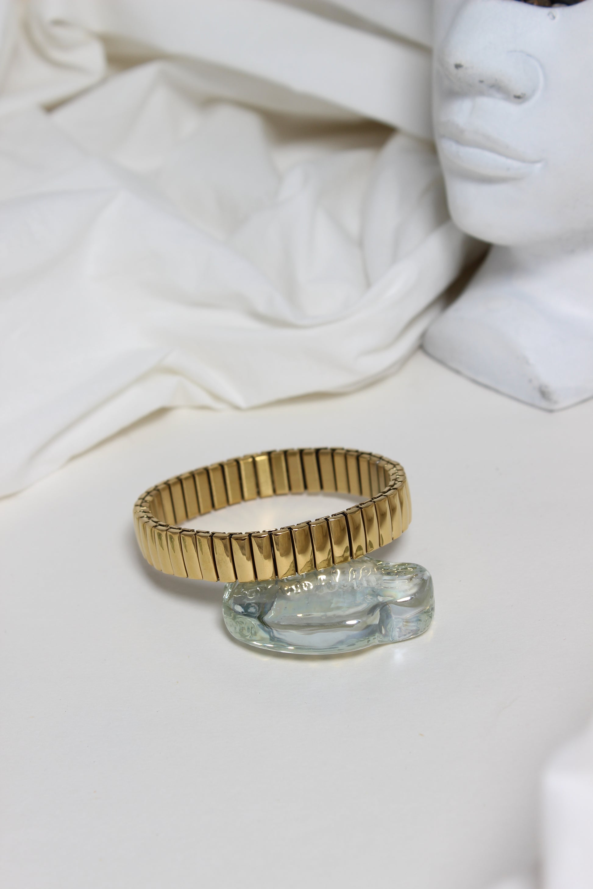 Gold and silver Timeless Gleam Bracelet on a white fabric background
