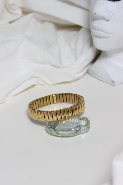 Gold and silver Timeless Gleam Bracelet on a white fabric background