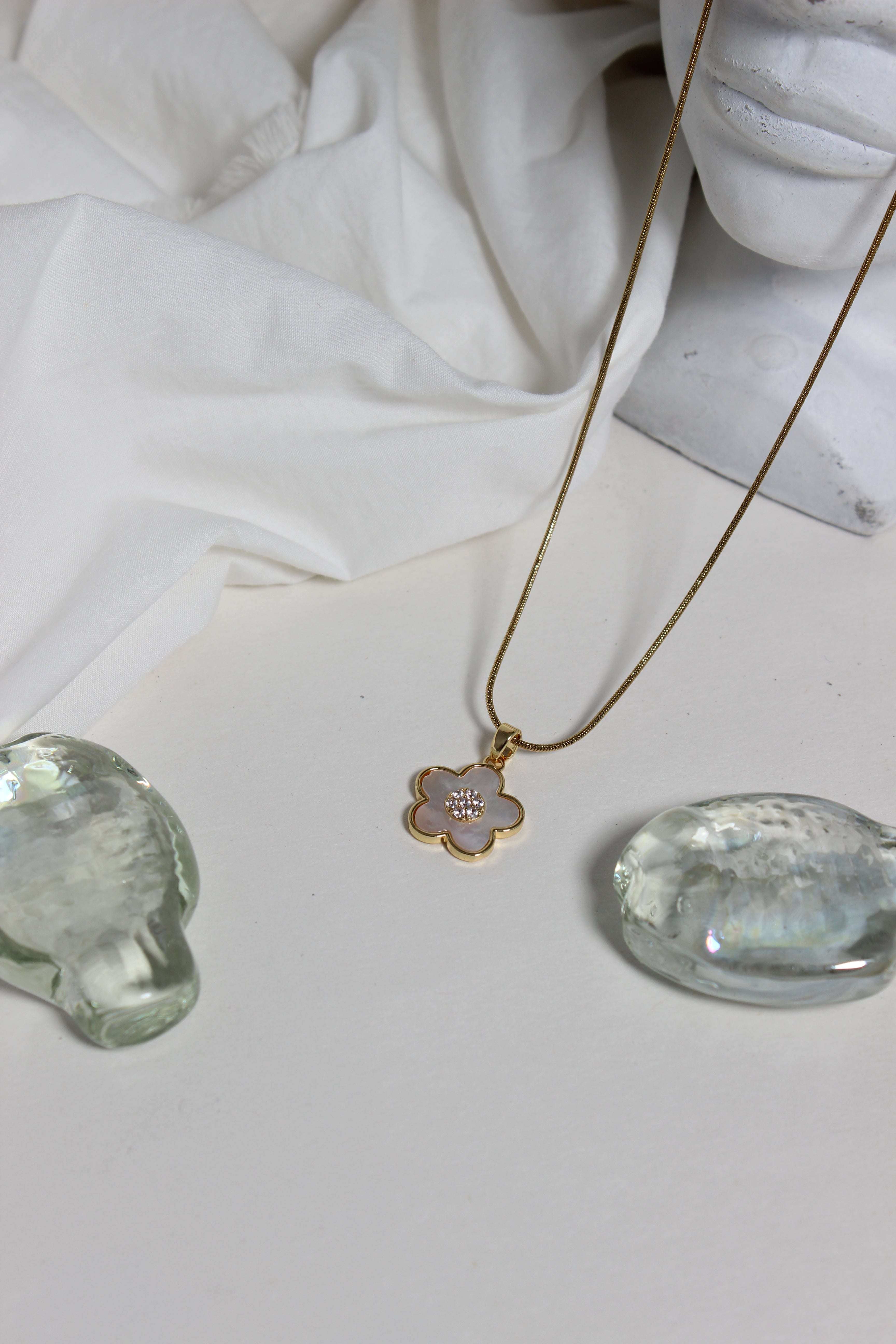 Moonflower Pendant Necklace on a white fabric background