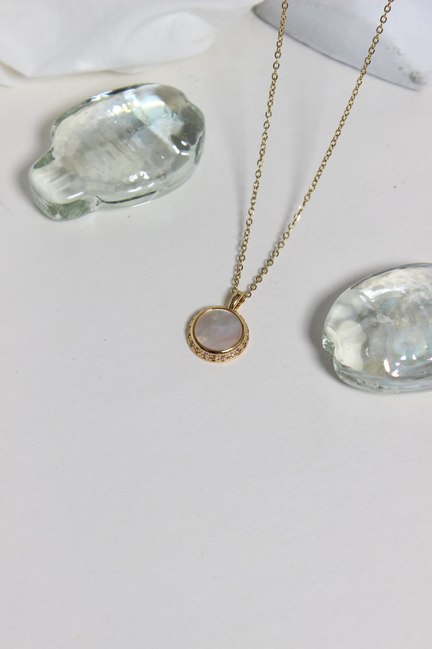 Iridesca Pendant Necklace on a white white surface 