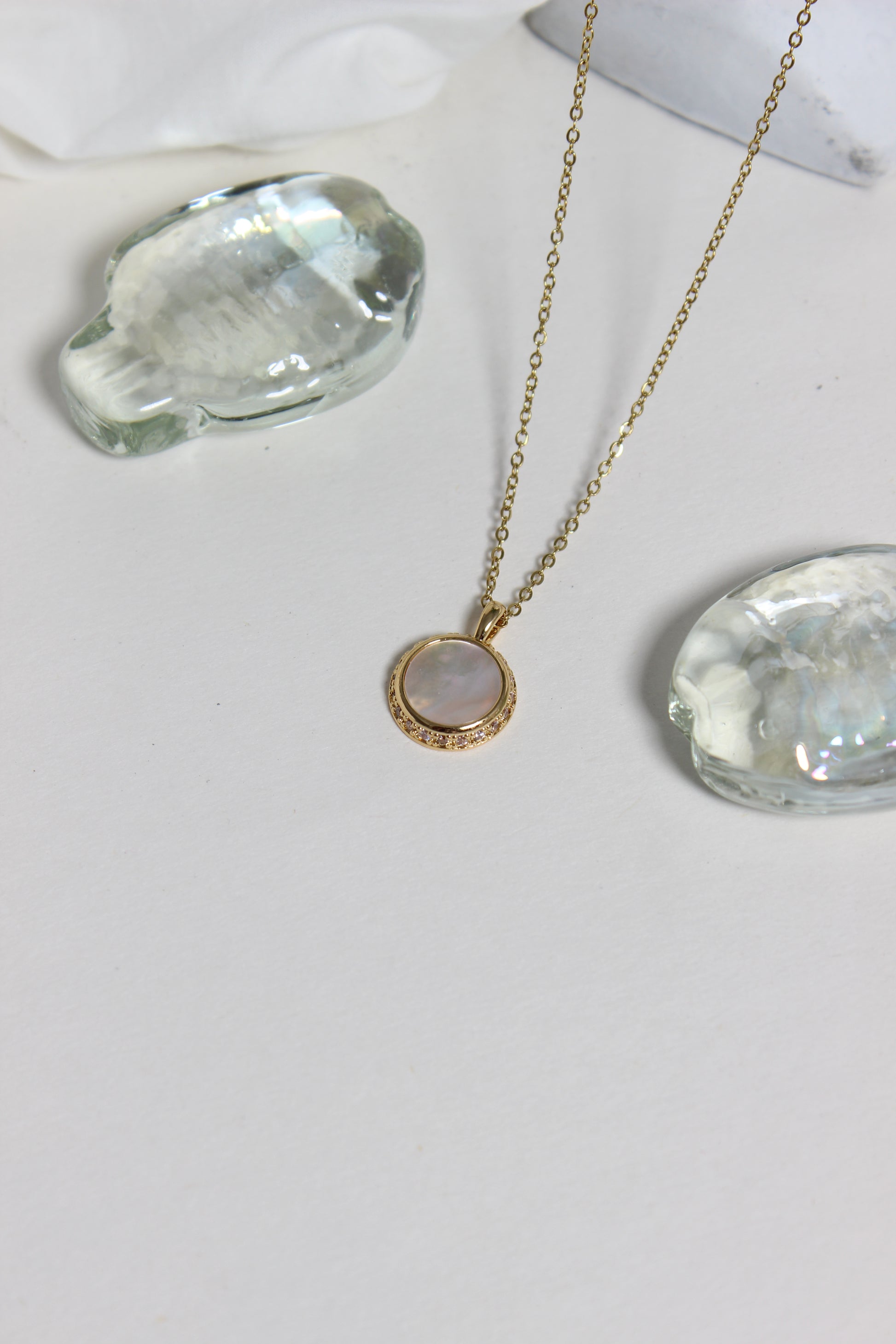 Iridesca Pendant Necklace on a white white surface 