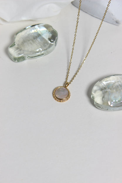Iridesca Pendant Necklace on a white white surface 