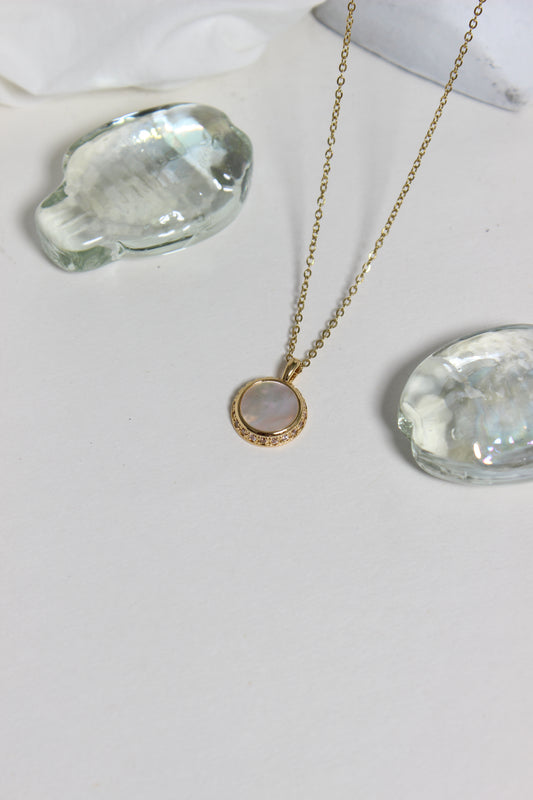 Iridesca Pendant Necklace on a white white surface 