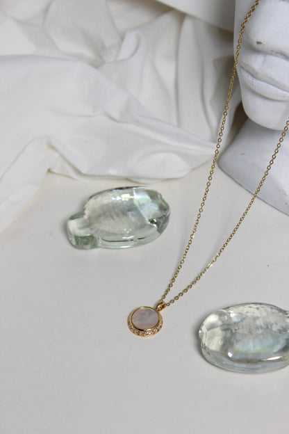 Iridesca Pendant Necklace with a marble bust in the background